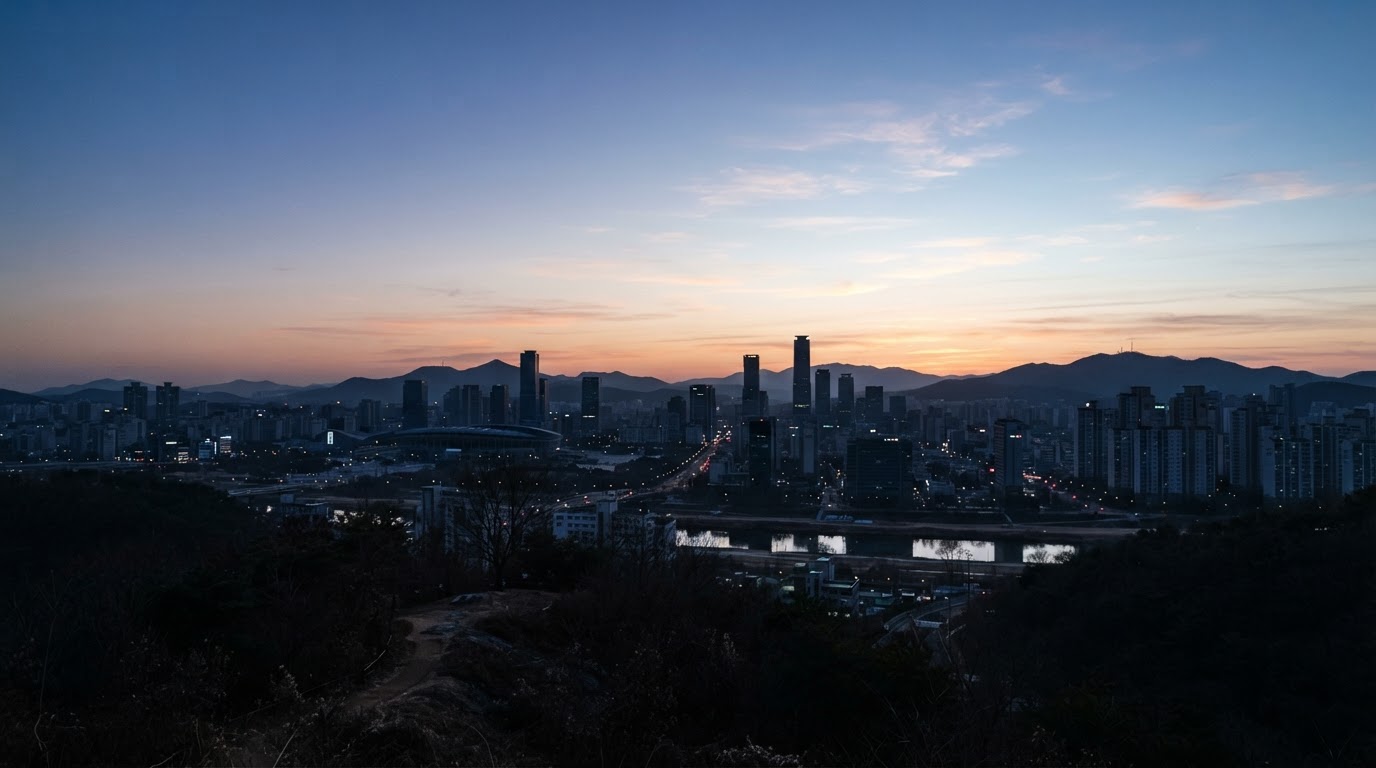 The sky over Daejeon brightening at dawn, a faint morning glow spreading over the winter skyline
