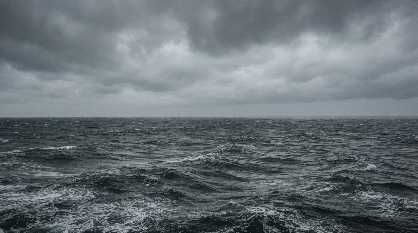 The gray water of the Sea of Okhotsk under a thick low ceiling of cloud, cold and empty