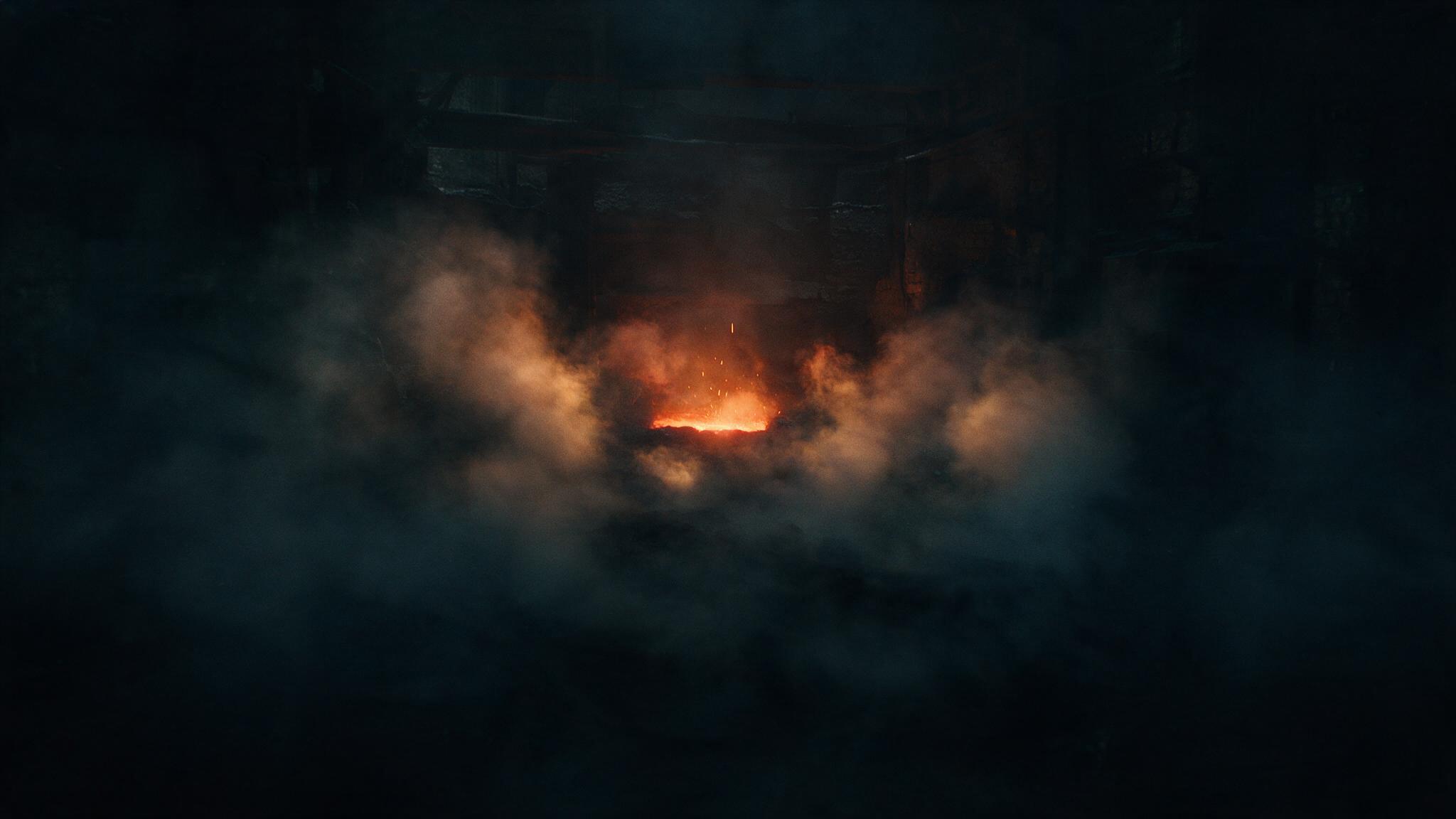 Abstract image of a dark foundry, the glow of red-hot bronze bleeding into the darkness, no people
