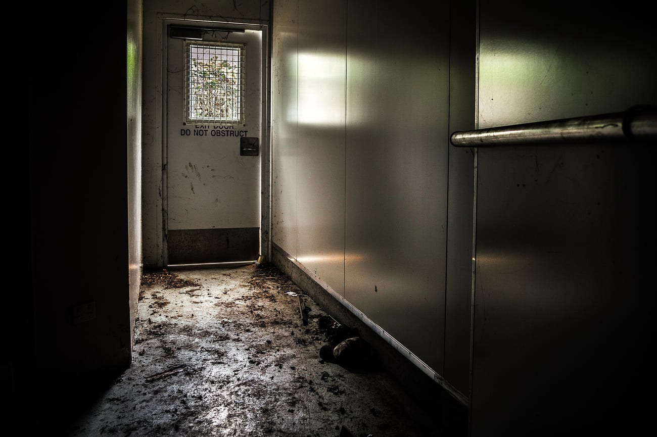 A dark doorway leading out of an unlit room — the setting a good ghost story needs. (darkday / CC BY 2.0)
