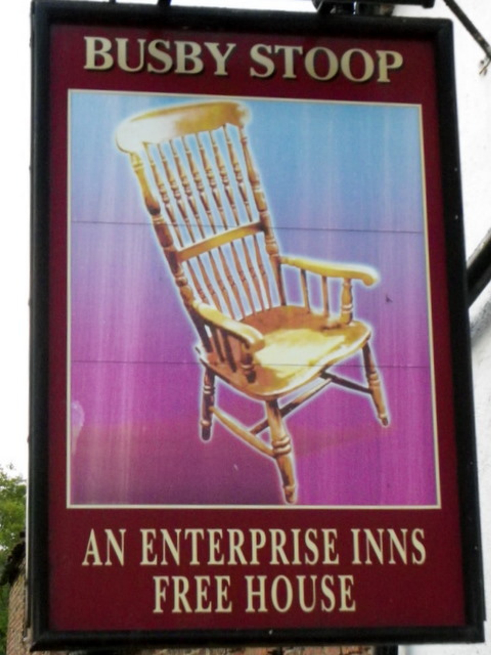 The pub sign of the Busby Stoop Inn, painted with the oak spindle-back chair at the centre of the legend