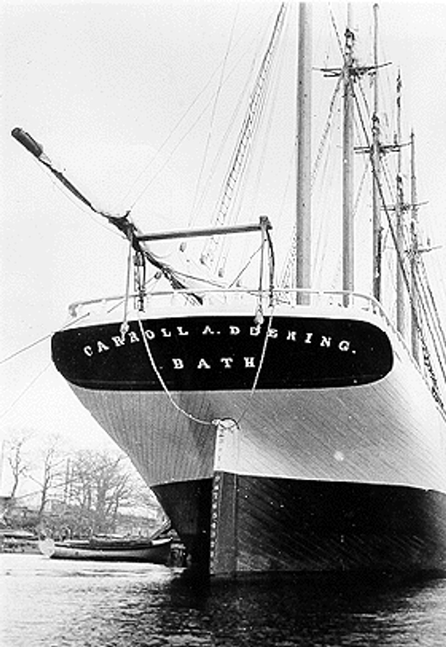 A close-up of the name CARROLL A. DEERING / BATH carved across the ship's stern