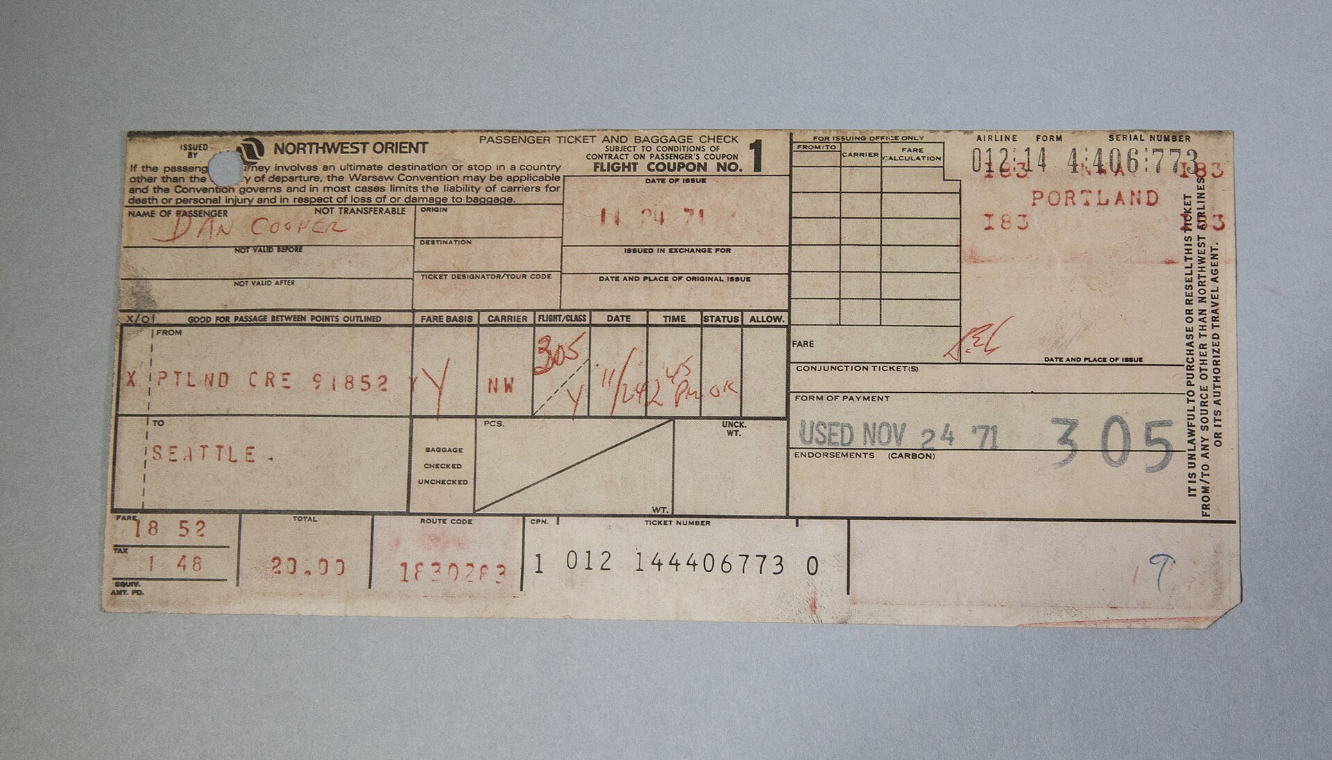 The surviving half of the actual ticket stub — passenger name 'DAN COOPER', Northwest flight 305 out of Portland, 24 November 1971. Physical evidence from the day itself