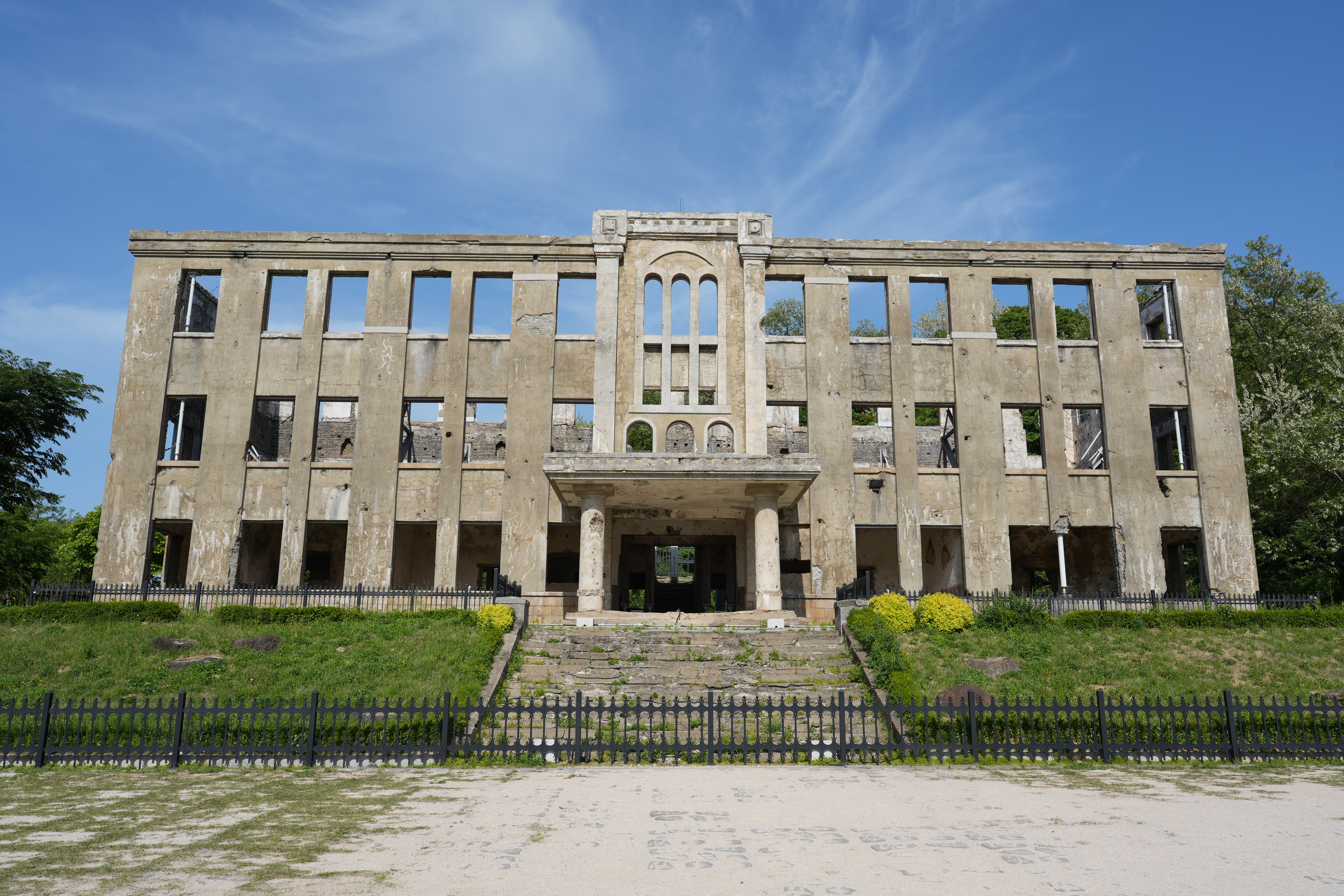 The Workers' Party Hall from the front — where each window should be, darkness has moved in.