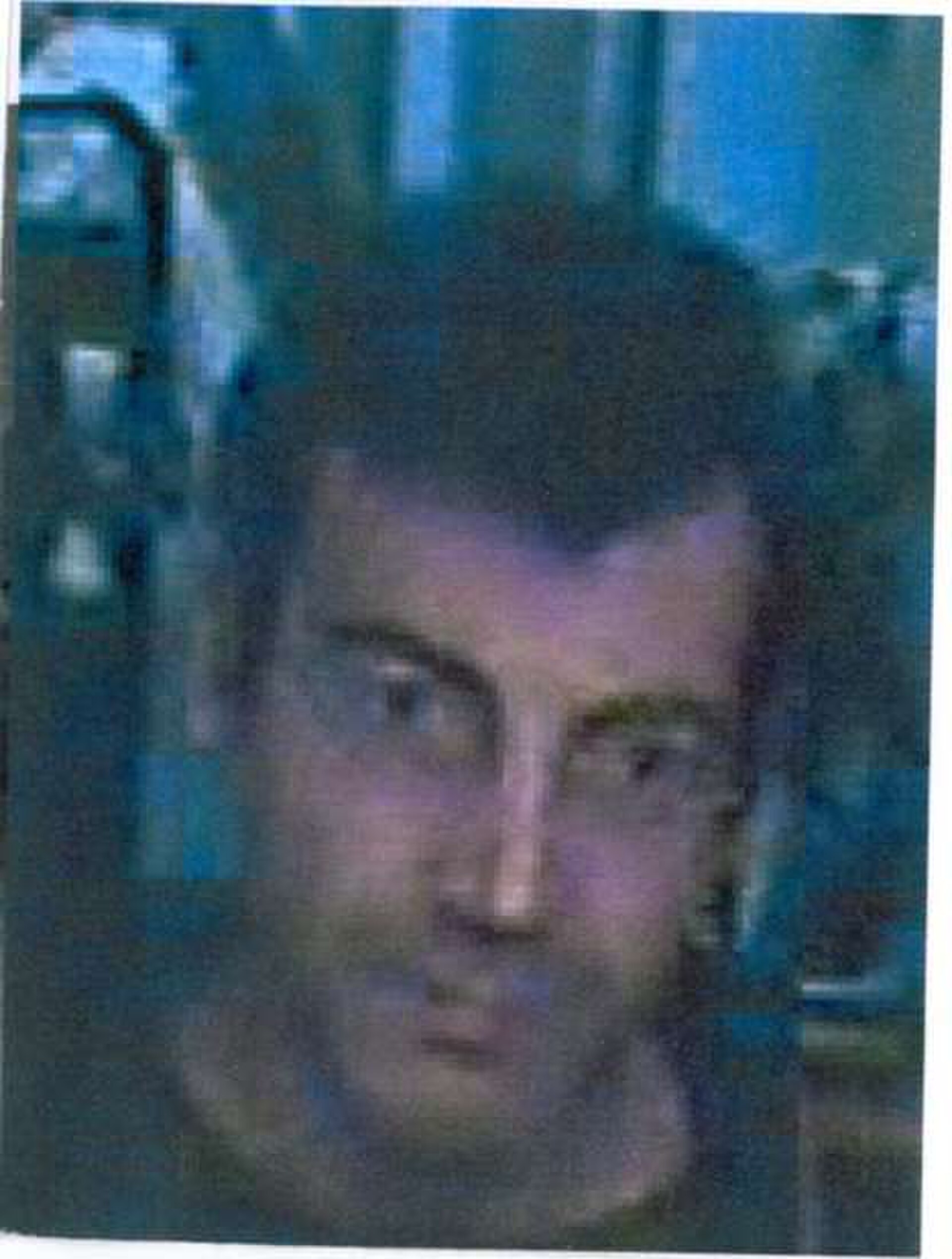 The last image ever captured of him: a coarse, heavily degraded frontal frame from a hotel security camera in Roquebrune-sur-Argens. After this, the trail ends completely.