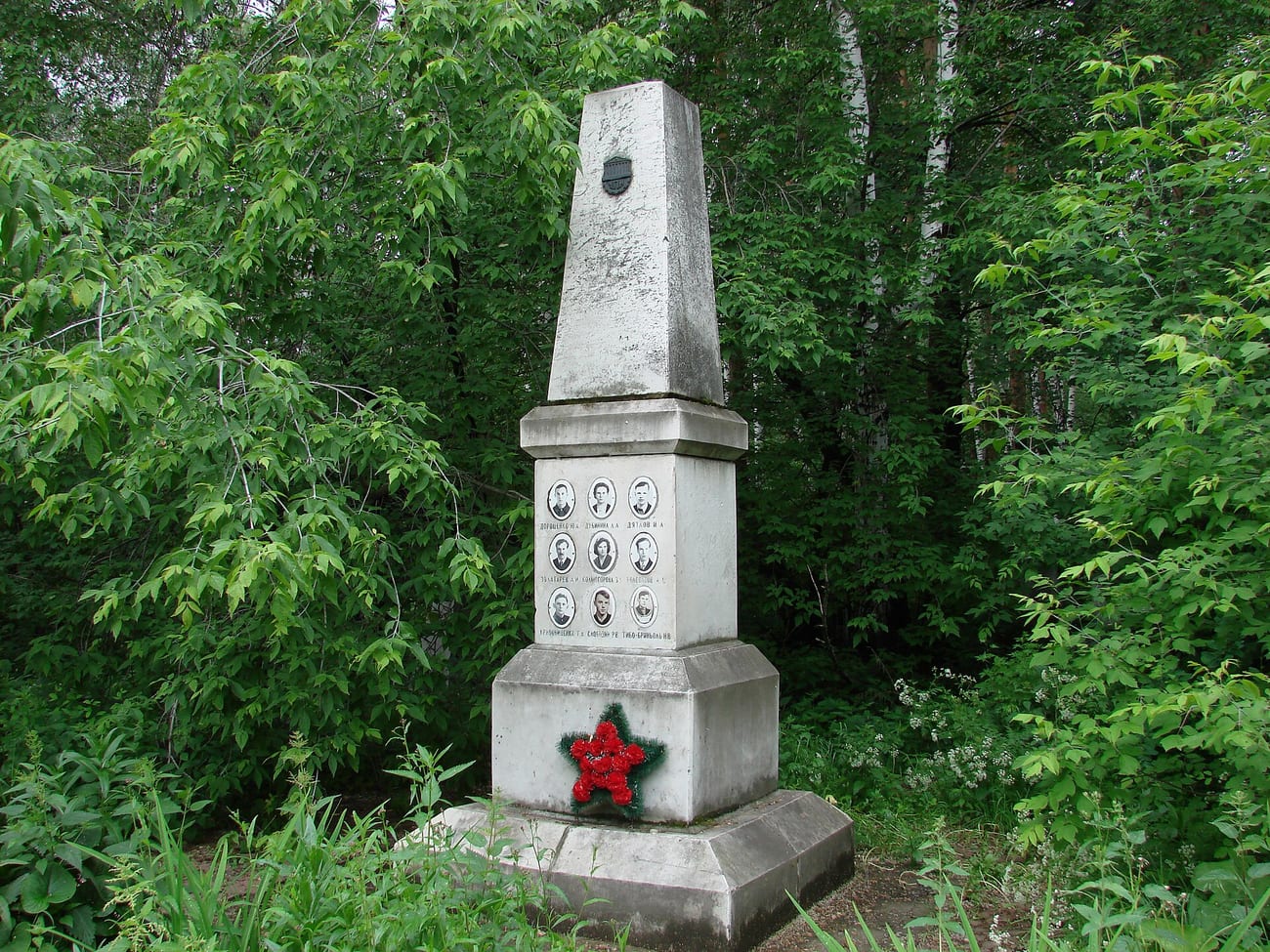 The memorial to the Dyatlov group at Mikhailovskoye Cemetery in Yekaterinburg, its face set with the nine hikers’ portraits.