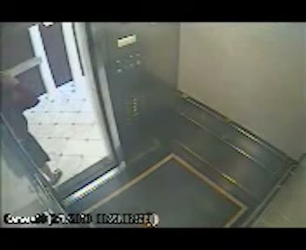 A later frame from the same recording: after the figure has moved out of shot, the elevator stands empty with its doors still open.