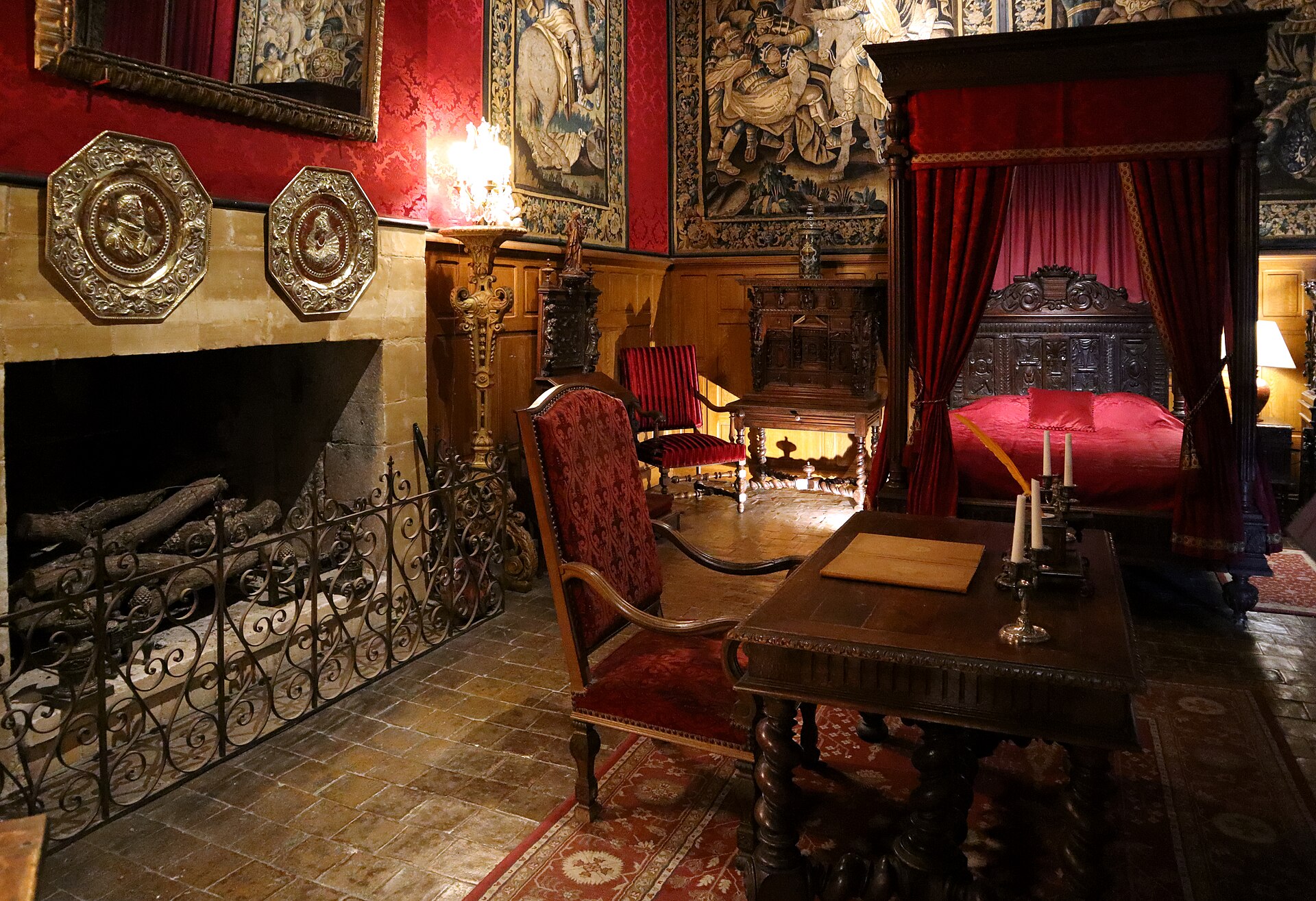 Inside the château: the Chamber of Louis XIII, with its red walls and tapestries, canopied bed and great fireplace.