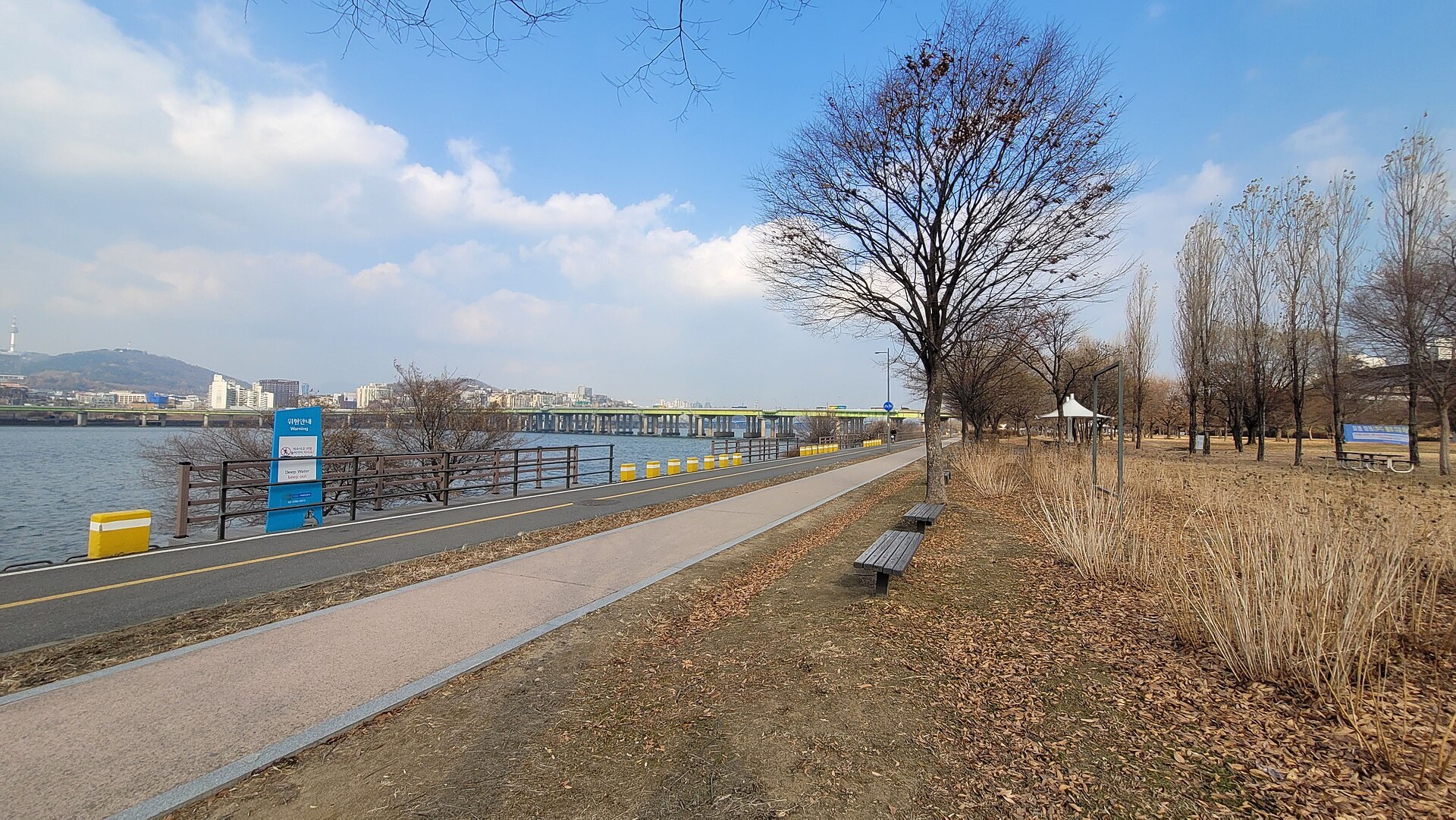 A riverside path along the Han River today. Nothing on the ground marks where any of this ended.