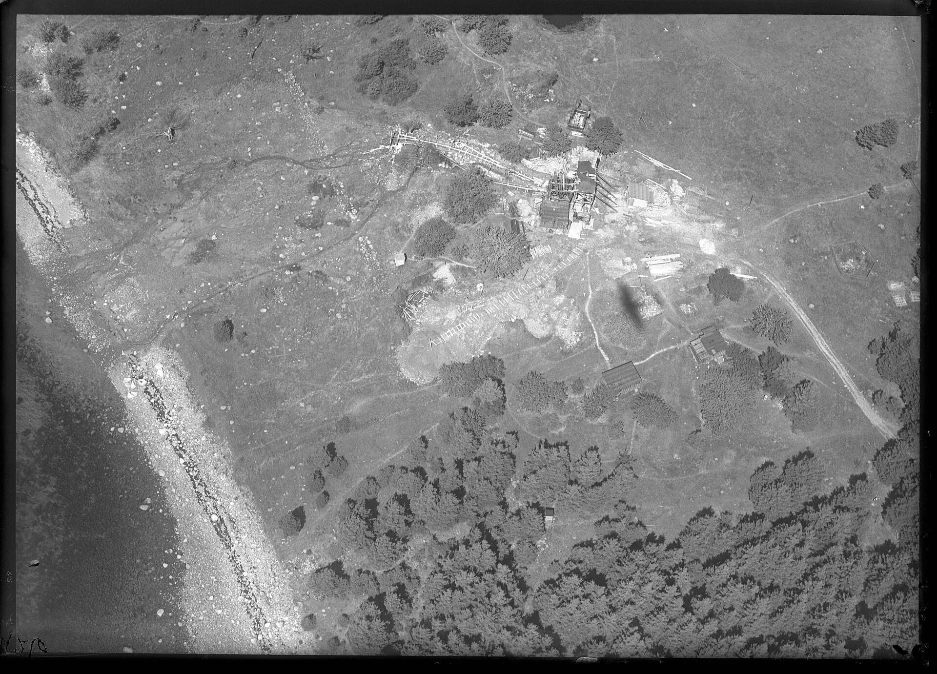 The Oak Island dig site from the air in August 1931 — the shafts, the tramway and the work buildings are all visible