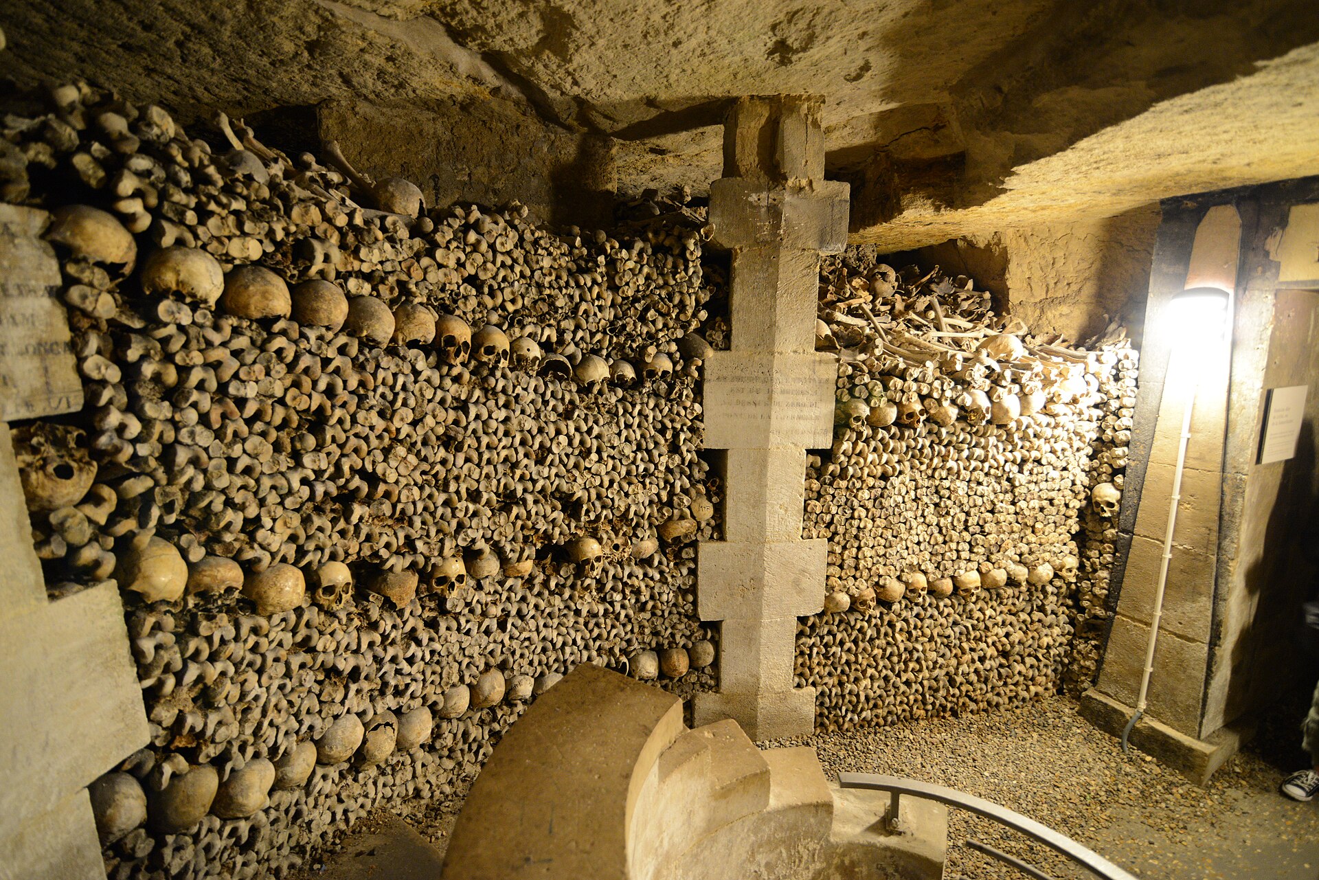 Skulls stacked in courses to form a wall — a close view of the ossuary facing in the catacombs