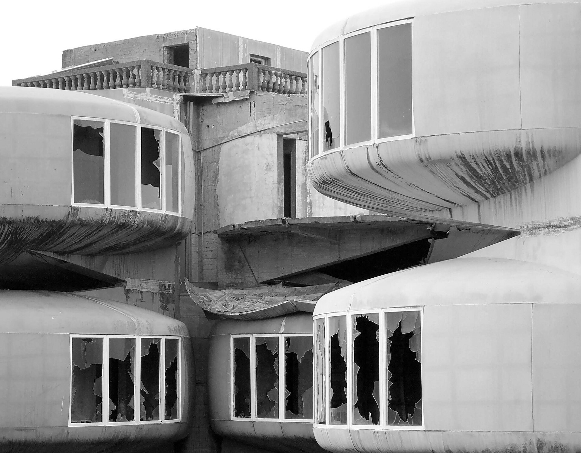 Four pods clustered together on their pillars, their windows broken out (Wikimedia Commons)