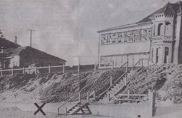 A 1948 press photograph of the discovery site — below the steps at Somerton beach, with an X marking where the body lay