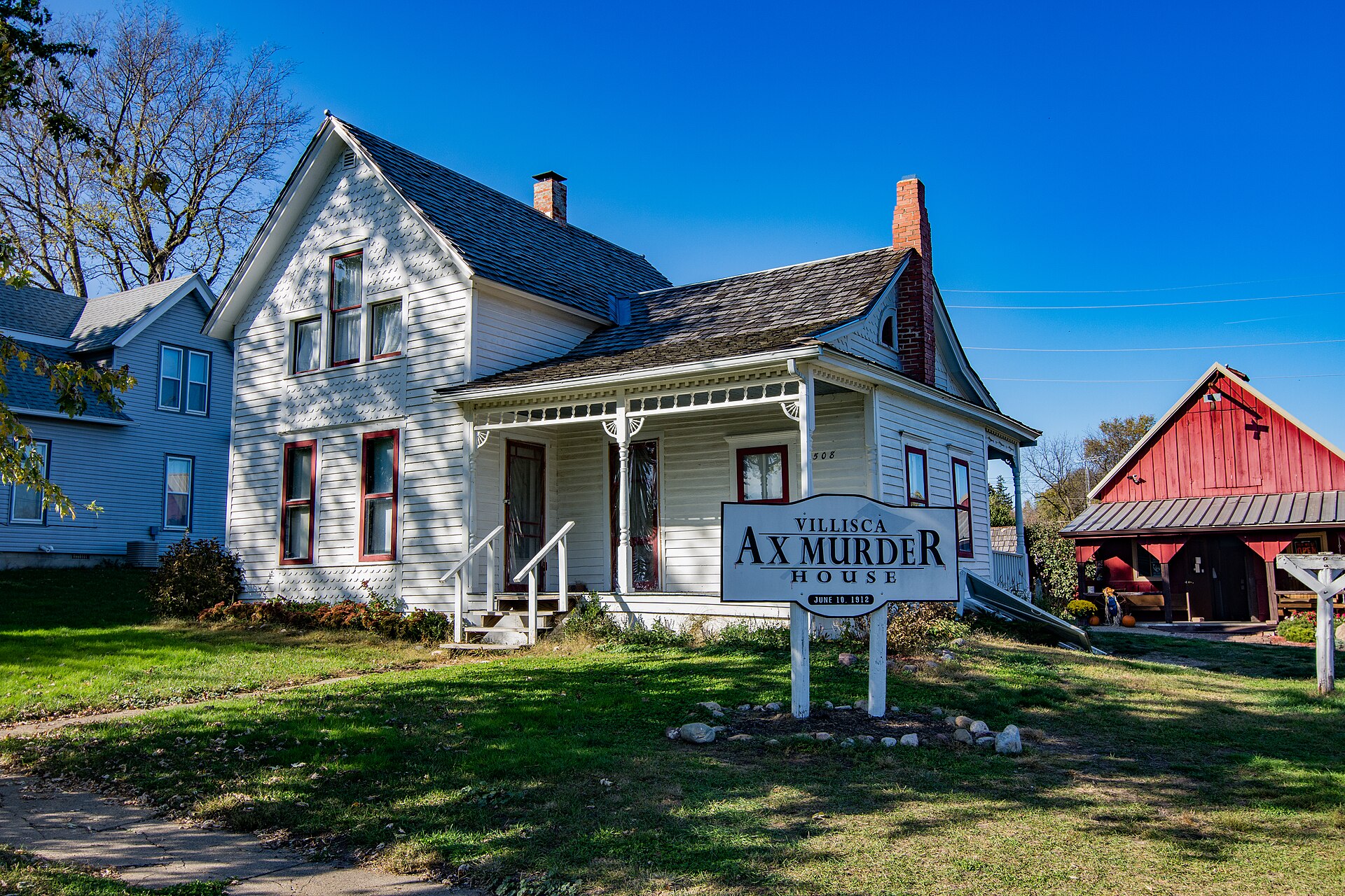 The Josiah and Sara Moore house — the crime scene still standing on the same street, now marked 'VILLISCA AX MURDER HOUSE / JUNE 10, 1912'