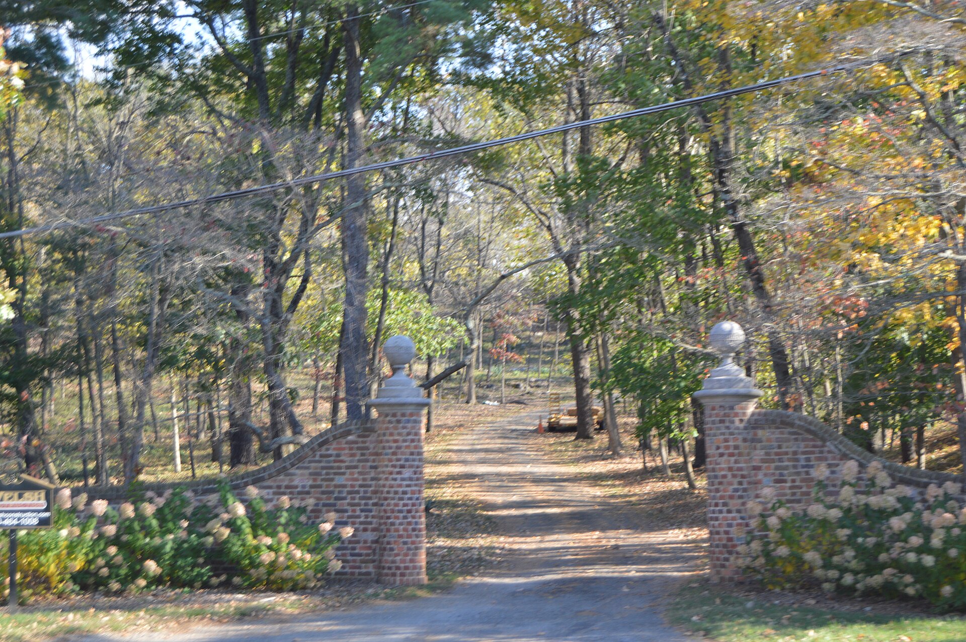 The old stone gateposts at the entrance drive up the hill — the way the patients were brought in still stands